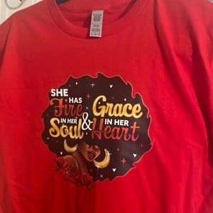 A large youth, red t-shirt with a beautiful colorful image.